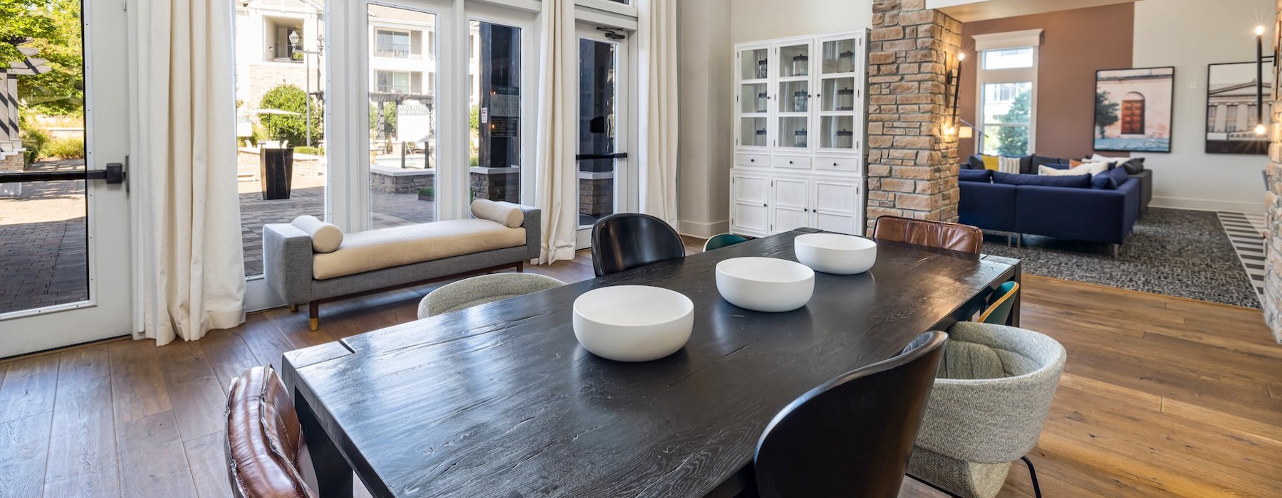 a clubroom with a table, chairs and a bench