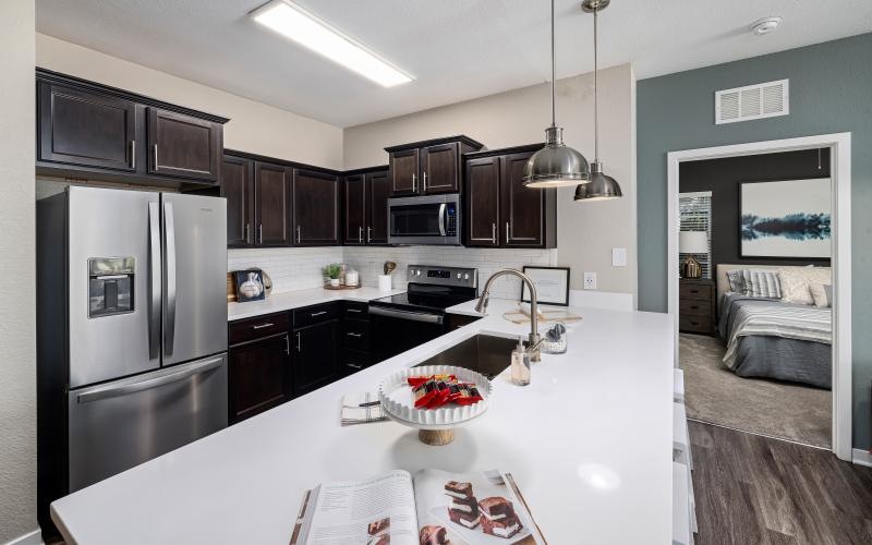 a kitchen with a counter and a refrigerator