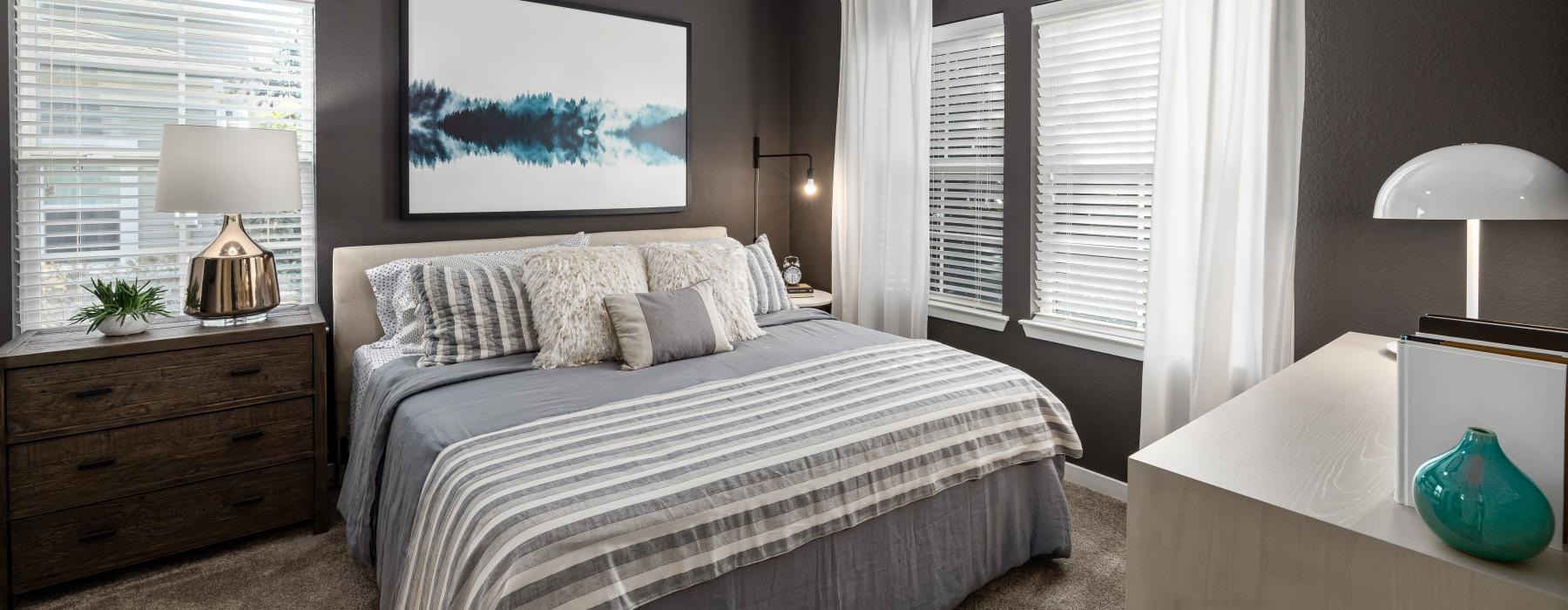 a bedroom with a bed and a dresser